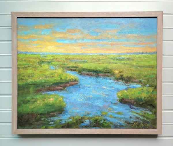 Framed painting of a landscape with a river and green fields.